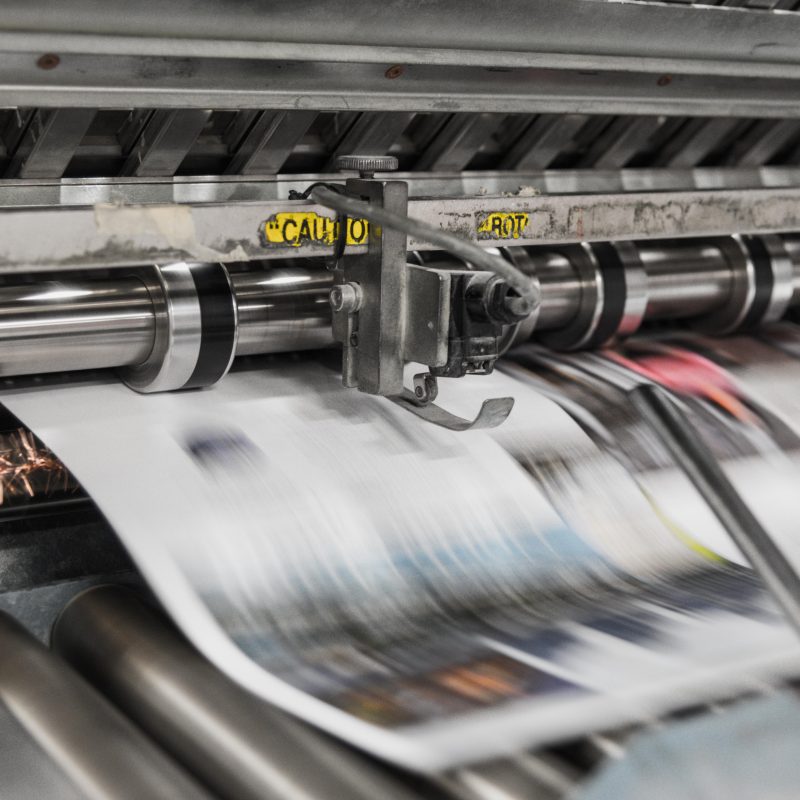 image shows a newspaper being printed on the machine