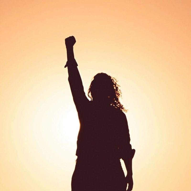 an image of a women in shadow in front of a bright white light